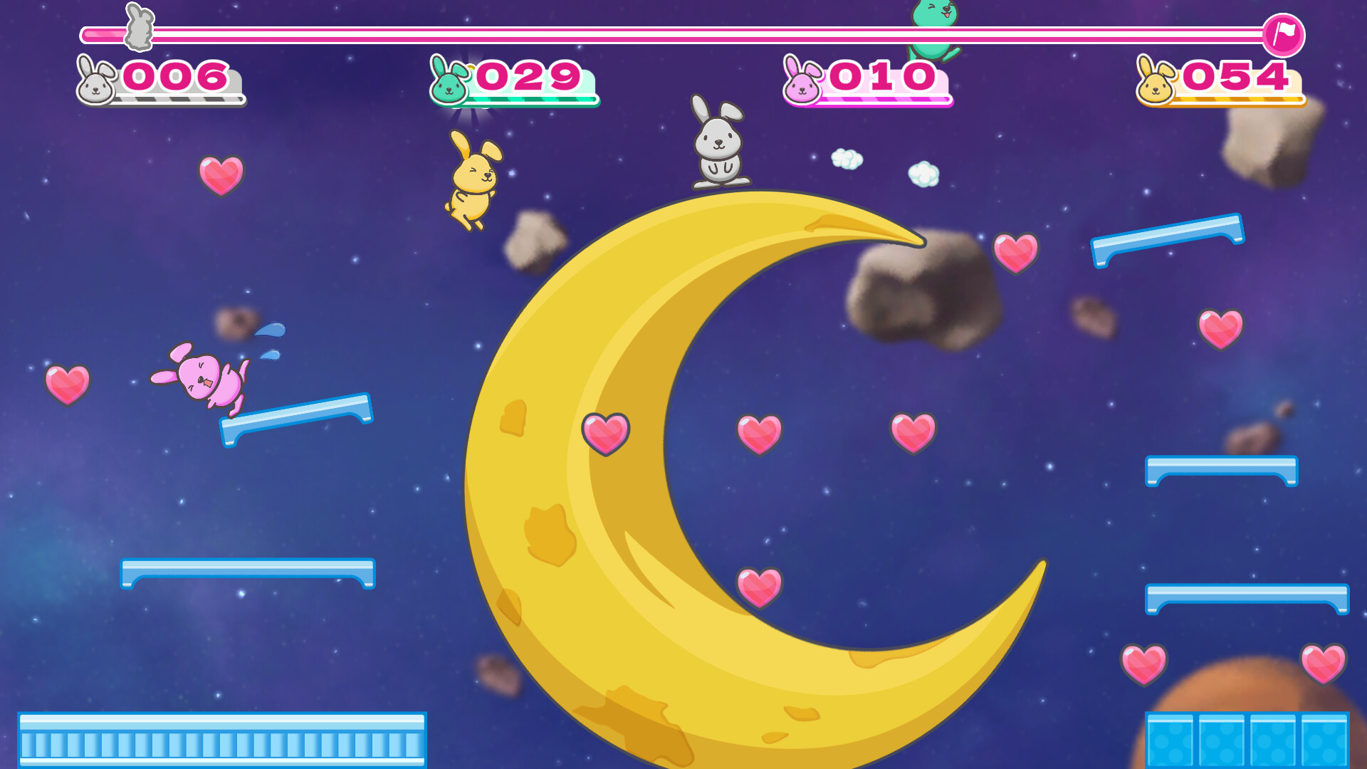 The image shows a colorful video game scene set in outer space with a large yellow crescent moon prominently displayed in the center. Four cartoon bunny characters, each a different color (gray, green, pink, and yellow), are positioned around the moon on various blue platforms. Pink heart icons are scattered throughout the scene, likely collectibles, and the background features a star-filled purple sky with floating asteroids. At the top of the screen, score counters for each bunny player are displayed in matching colors.