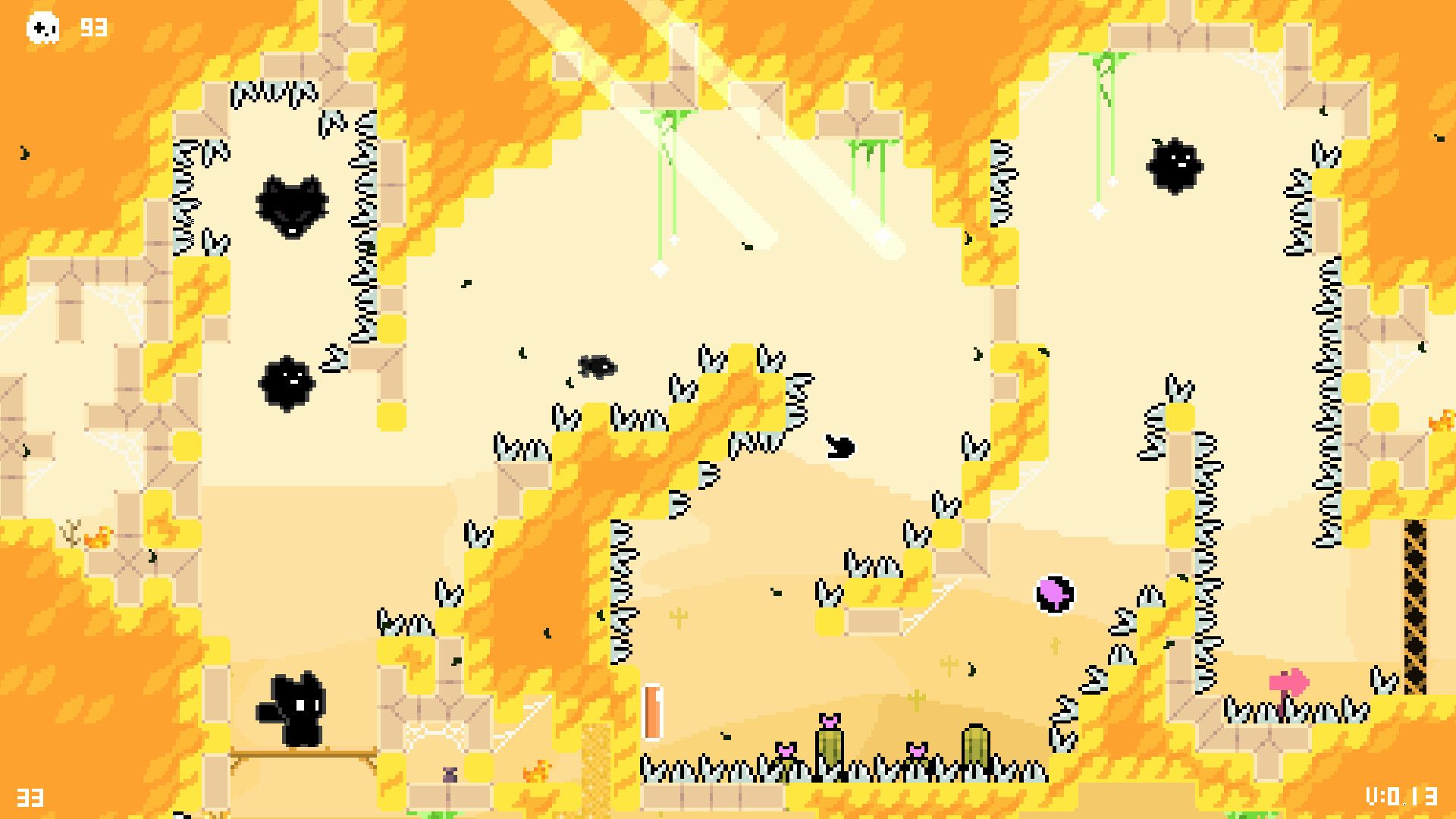 The image shows a pixel art scene from a video game featuring a small black character standing on a wooden platform on the left side. The environment is dominated by bright yellow and orange tones, representing a fiery or desert-like theme, with beige platforms and numerous sharp spikes arranged throughout the level. There are also several black, round, spiky enemies floating or attached to walls, and a pink circular collectible object near the center-right. The layout includes narrow pathways, vertical and diagonal sections, and small patches of green cacti with pink flowers near the bottom center.