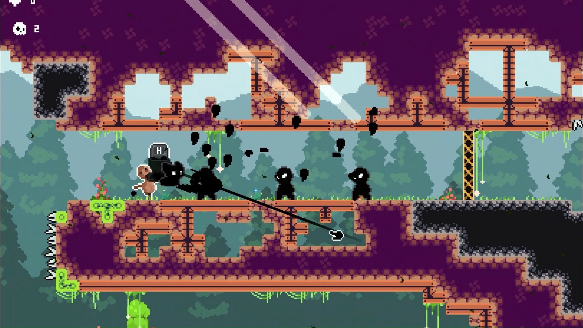 The image shows a pixel-art style video game scene set in a forest environment with green trees in the background. The main platform is made of brown and purple blocks, with some green slime and vines hanging down. On this platform, several small black shadowy figures with glowing eyes are standing, while a larger character on the left, wearing a helmet marked with an 'H,' appears to be attacking or interacting with one of the shadowy figures using a long black lance or spear. The top left corner of the screen displays game interface elements, including a heart symbol and a skull icon with the number 2 next to it, likely indicating lives or health. There are also spikes visible on the far left.