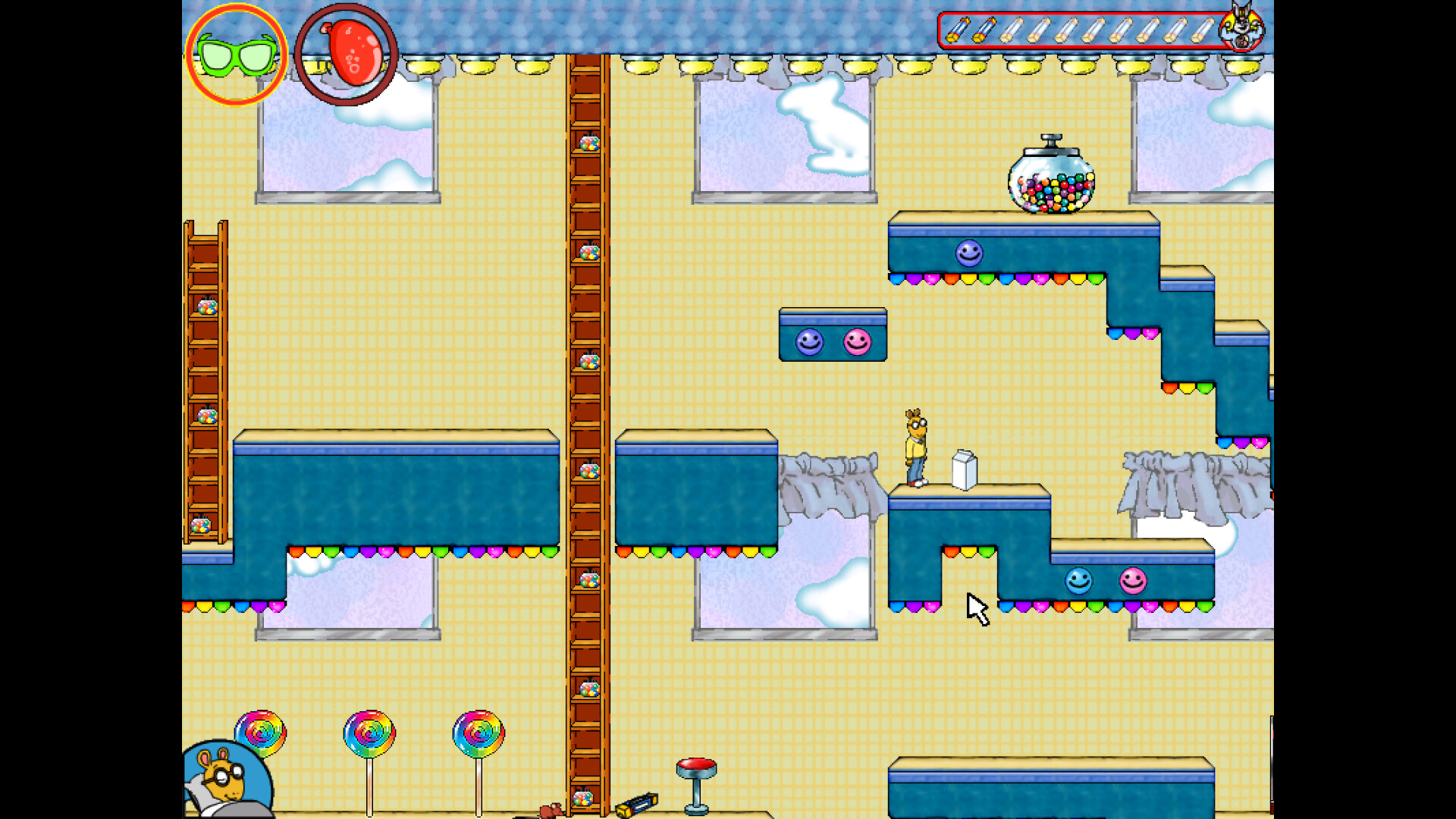The image shows a colorful 2D platform-style video game scene set inside a house with a yellow grid-patterned wallpaper and large windows revealing a blue sky with white clouds outside. The playable character is a cartoon aardvark wearing a yellow shirt, white pants, and red sneakers, standing on blue platforms decorated with multicolored light bulbs. There are wooden ladders with candy-filled jars on every rung, a large gumball machine on a platform above, and large rainbow-colored lollipops scattered on the floor. At the top of the screen, game interface elements include a pair of green sunglasses, a red tomato-like icon, and a row of items indicating game progress or inventory.