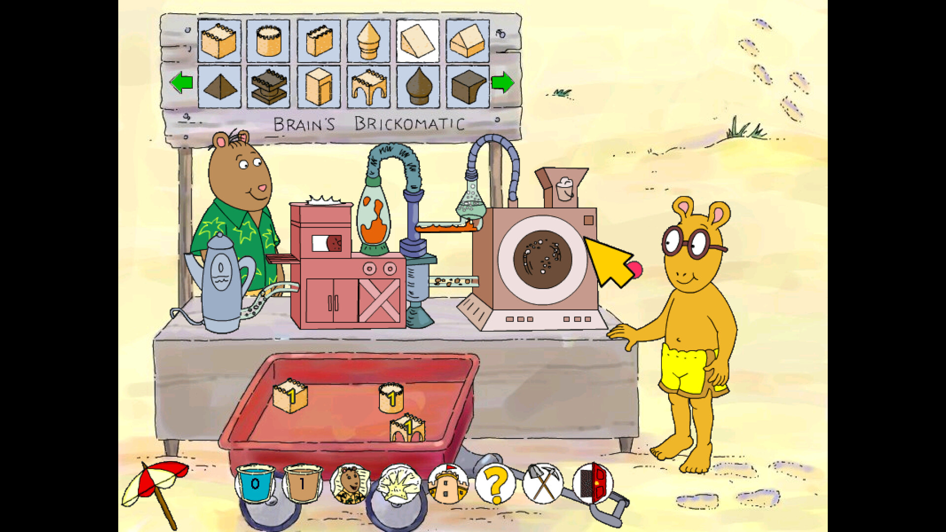 The image depicts two anthropomorphic bears in a sandy outdoor setting, engaged with a machine labeled "Brain's Brickomatic." The bear on the left, wearing a green shirt with yellow stars, stands behind the machine that has various tubes, containers, and a washing machine-like component with a large circular window. The bear on the right, wearing yellow shorts and glasses, is standing barefoot on the sand reaching toward the machine. In front of them is a red wagon containing small yellow brick-shaped objects, and above the machine is a display panel showing different brick shapes. The scene appears to be part of an interactive or educational activity involving building bricks.