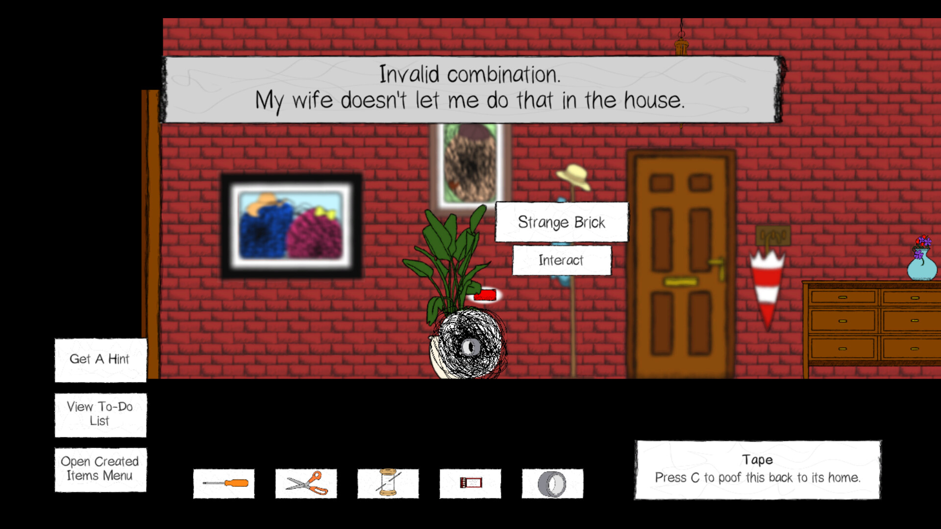 The image shows a scene from a video game with a red brick wall background featuring a door, a dresser with a vase of flowers, a coat rack with a hat, and two framed pictures on the wall. In the center, a potted plant labeled "Strange Brick" is selected with the option to "Interact." A message at the top reads, "Invalid combination. My wife doesn't let me do that in the house." At the bottom are icons representing tools and items such as a screwdriver, scissors, thread, a ticket, and tape, along with a prompt saying, "Tape: Press C to poof this back to its home." Additional menu options are visible on the left side: "Get A Hint," "View To-Do List," and "Open Created Items Menu."