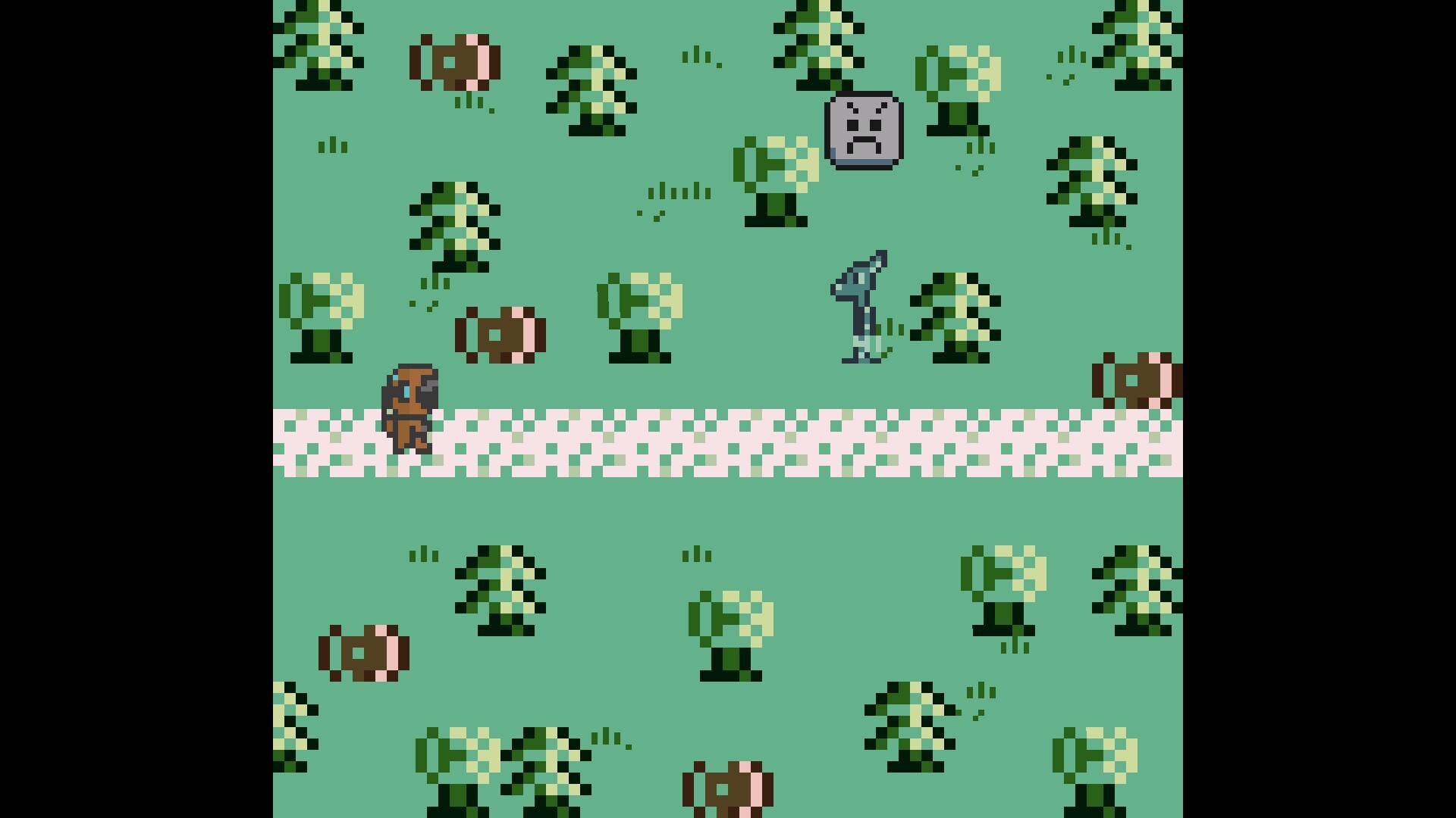 The image is a pixel art scene depicting a top-down view of a grassy area with scattered trees and bushes. A light-colored gravel path runs horizontally across the middle, with a small sprite resembling a cloaked figure walking on it from left to right. Nearby, there are brown barrels scattered around, a gray stone block with a frowning face, and what appears to be a small animal or creature standing upright on two legs near the stone block. The overall color palette is muted greens, browns, and grays.